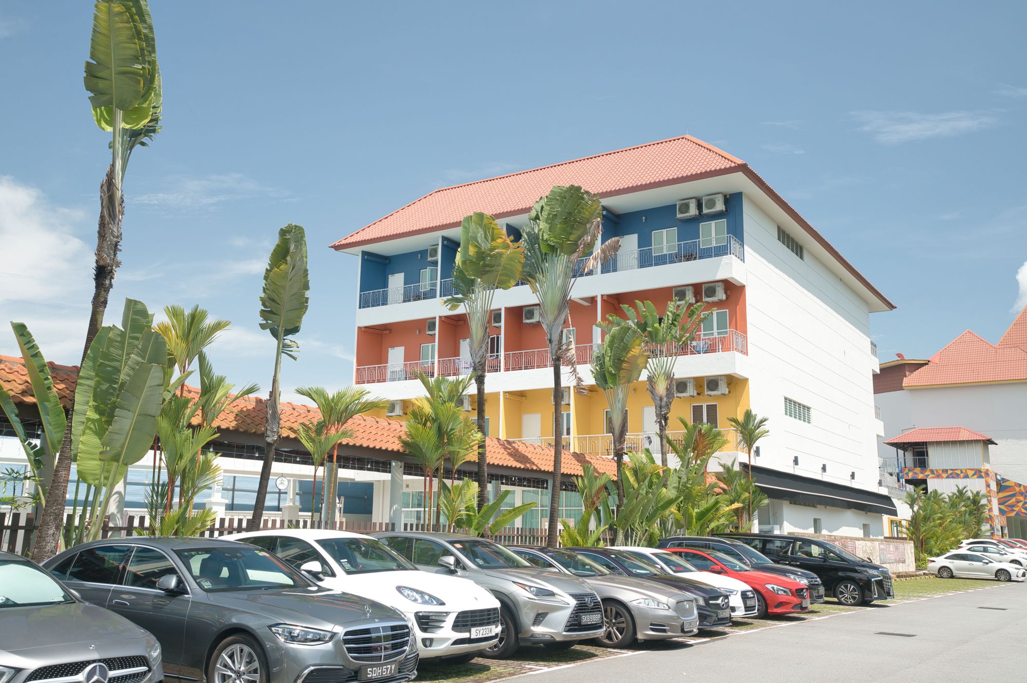 Cove's latest building located at Jurong, with cars at the carpark